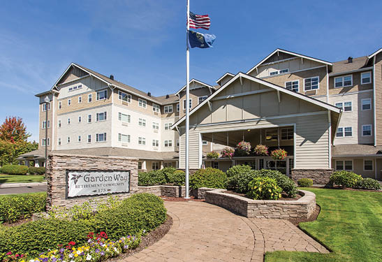 A large building with a flag on top of it. The building has a flag pole and a sign in front of it. The building is made of brick and has a large window. AI generated content